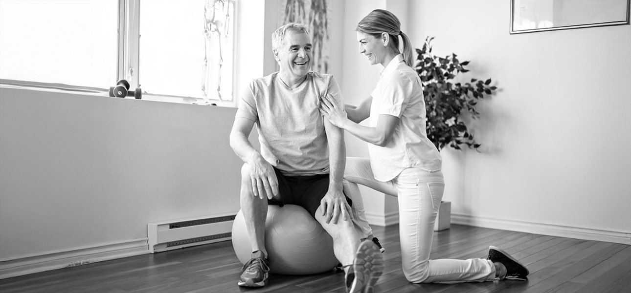 Modern rehabilitation physiotherapy worker with senior client